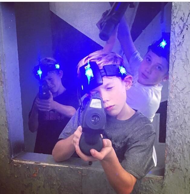 three kids with laser tag gear